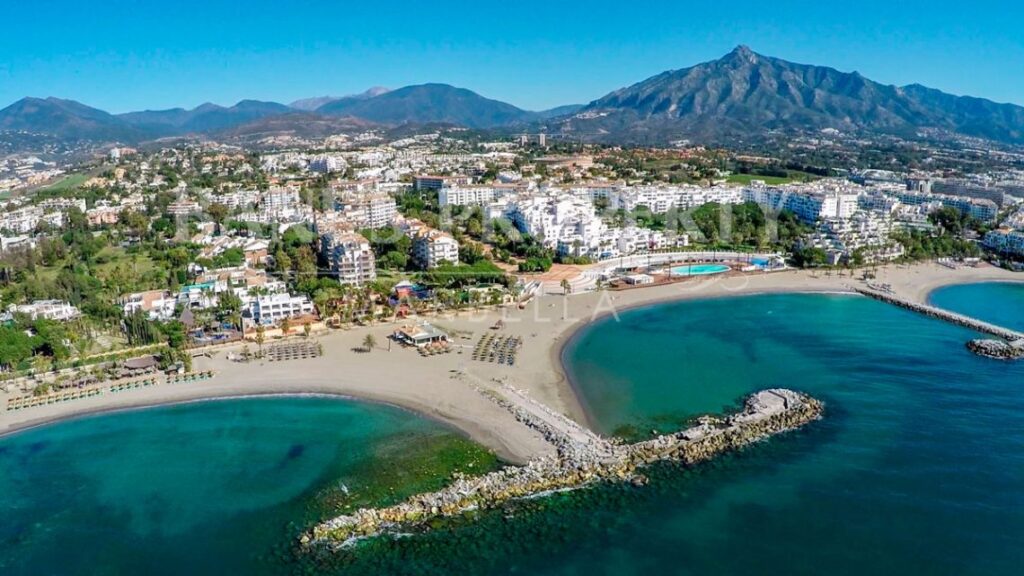 Beach In Puerto Banus, Marbella, Spain Marbella Is A Popular Holiday  Destination Located On The Costa Del Sol In The Southern Andalusia, It Lies  Beneath The Cordillera Penibetica Mountains Stock Photo, Picture