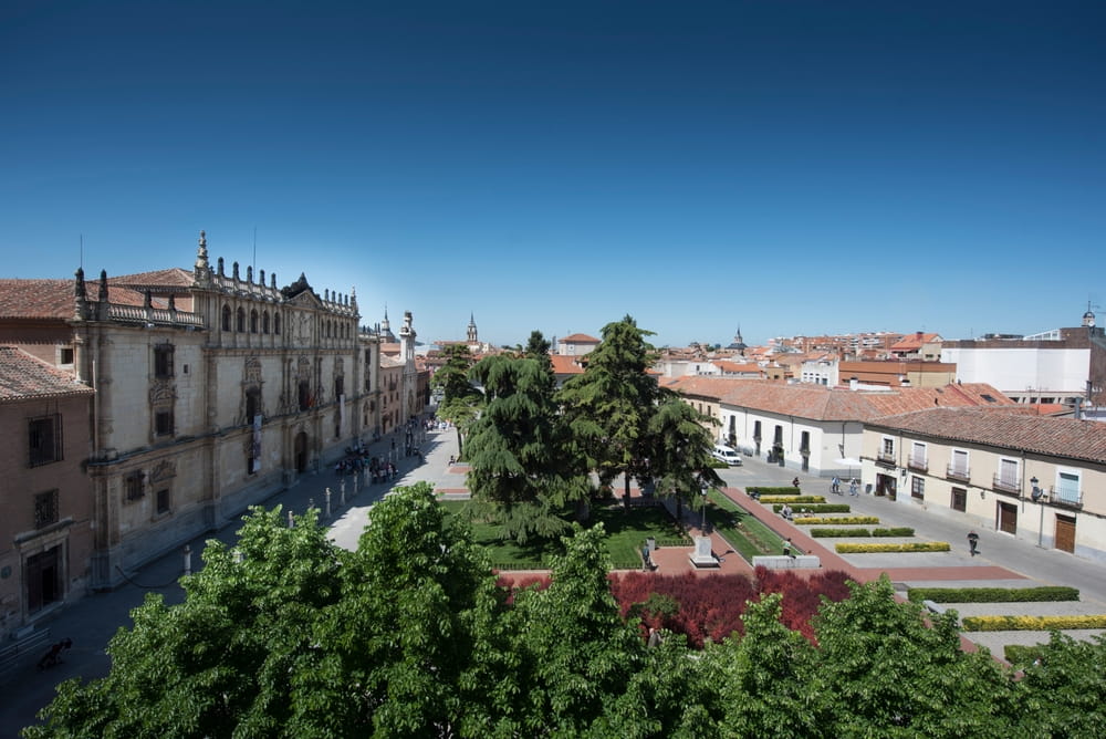 Historic university square in Alcalá de Henares near Madrid with gardens and old buildings