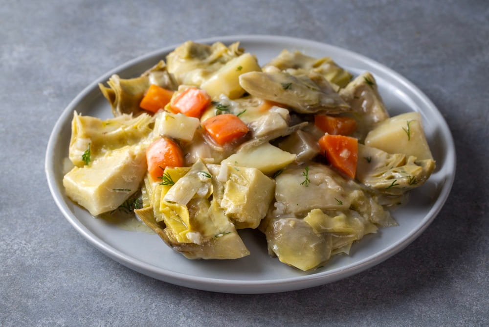 Traditional Spanish artichoke stew with potatoes and carrots, showcasing a classic Mediterranean vegetable dish.